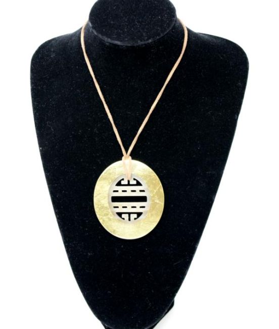 Pendant with gold outer and carved inner