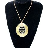 Pendant with gold outer and carved inner